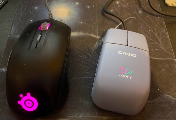 Two mice. One is black with pink lights, and is larger than the Loopy mouse, pale lavender and rectangular