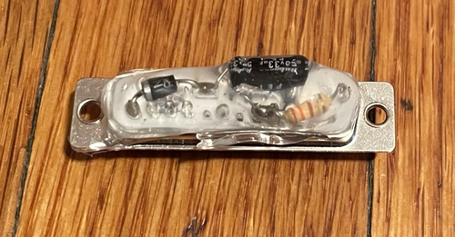 A DB25 connector with a potted capacitor, diode, and resistor