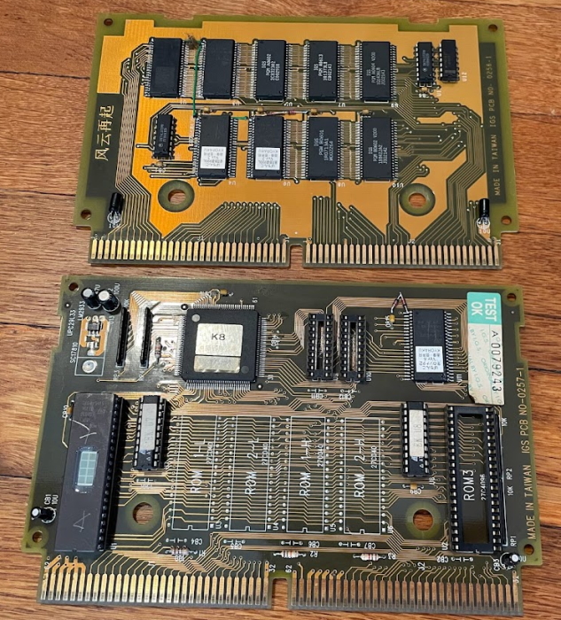 Two PCBs. The lower one shows minor rework