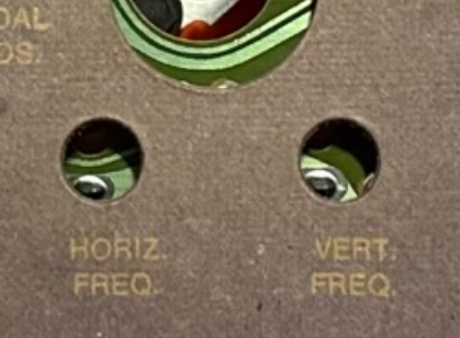 The cardboard cover for the Odyssey 100, showing HORIZ FREQ and VERT FREQ as different adjustments
