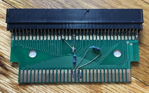 A modded NES to Famicom converter with resistors soldered on