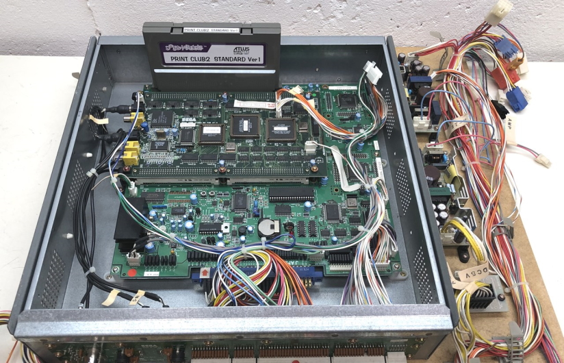 An ST-V Print Club 2 board, with a wiring harness, including one attached to CN22