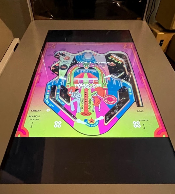 My modded Toyshock, as seen in other articles, running Atari Video Pinball. There is a colorful background and the actual moving parts of the board are white overlays