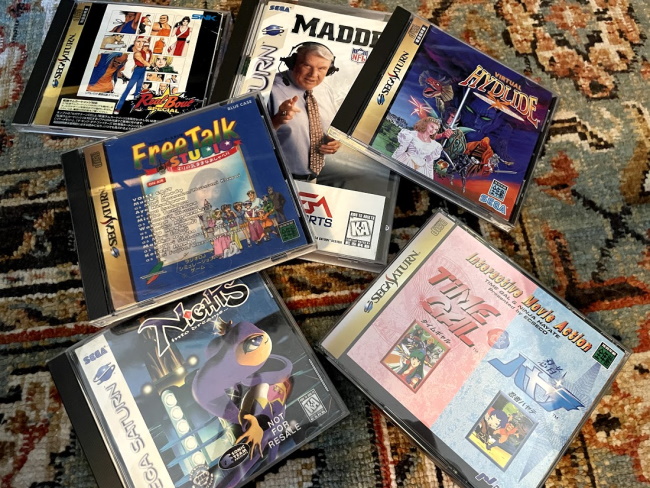 A pile of Saturn games on the floor
