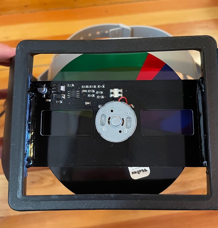 A spinning color disc behind a black circuitboard