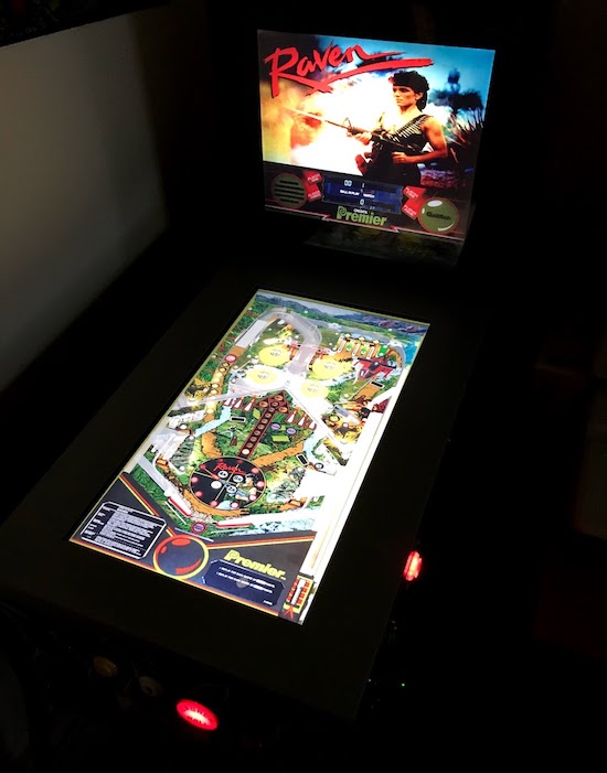 The modded pinball in the dark, showing two screens and the Gottlieb game 'Raven'