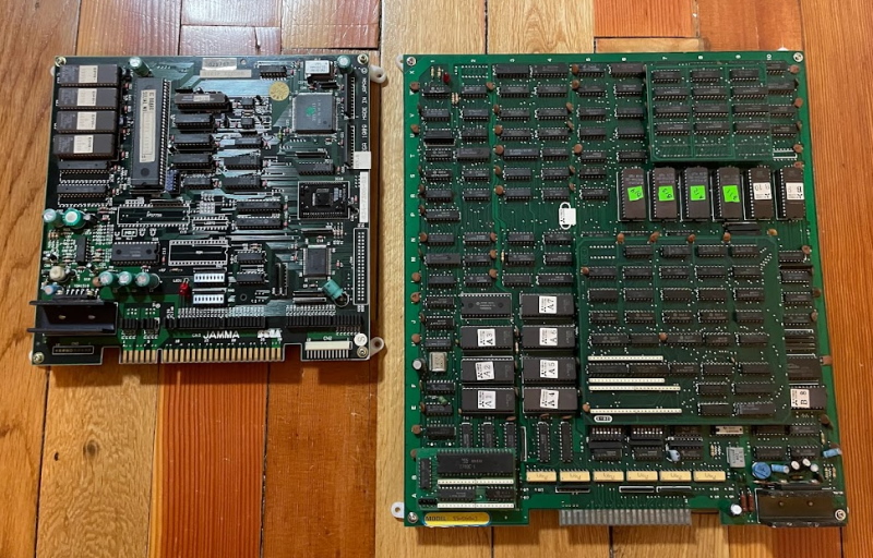 A circuitboard on the floor next to a larger one