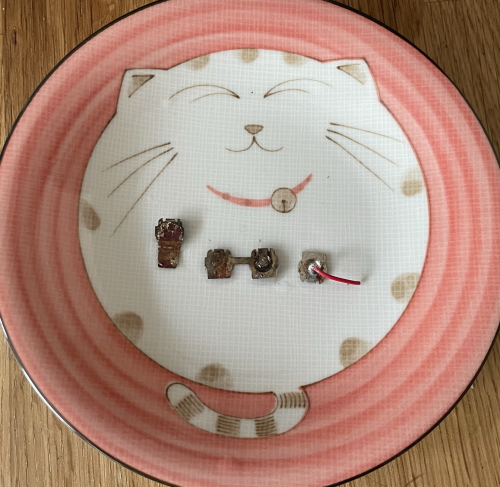 a cat shaped bowl with some rusted metal in it