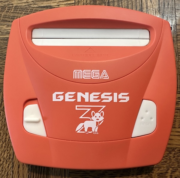 more game consoles need foxes A genesis 3 in orange. It's labeled 'MEGA' not SEGA.