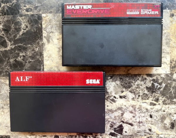 Two Master System cartridges. One is the Everdrive X7 flash cart, the other is ALF.