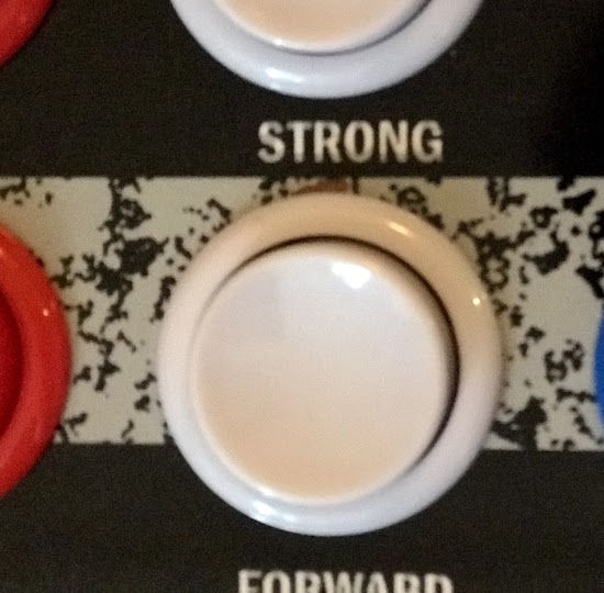 A closeup of the table, showing a tiny nick above one of the buttons
