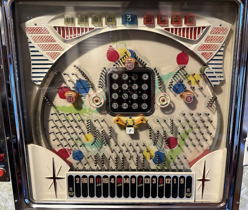 A playfield of balls falling into numbered pockets