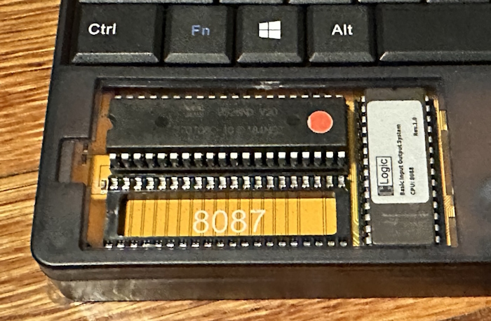 Compartment on the Book 8088 showing the NEC V20 CPU, an open FPU socket, and a BIOS EEPROM