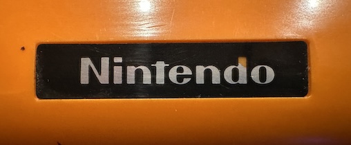 The Nintendo logo from the case above. There's a chip in the art.