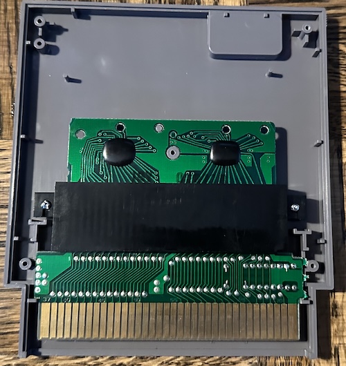 Gyromite NES cartridge interior; two PCBs connected by a black joining piece