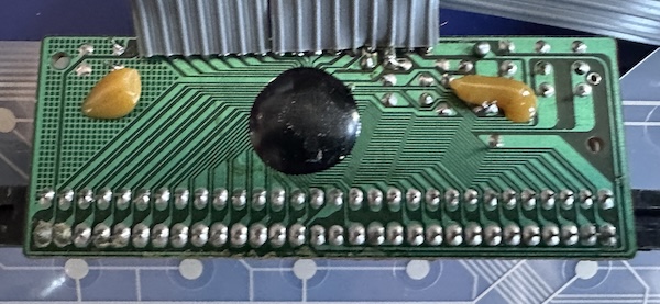 A tiny PCB with a cartridge slot and an epoxy blob