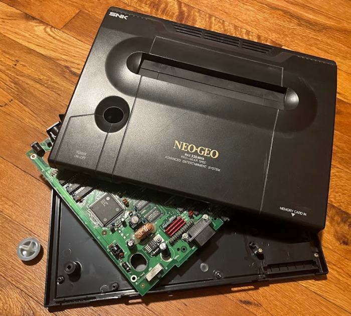 A Neo Geo console broken into pieces