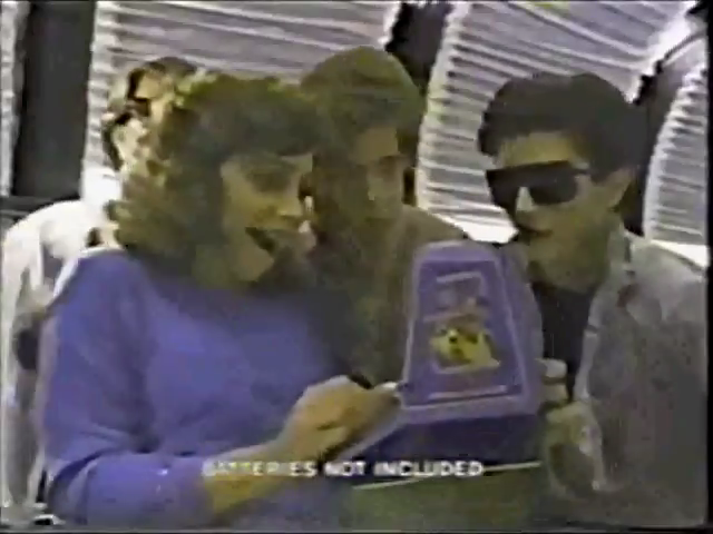 the ad heavily implies that this couple is desperate for a threesome with ms. pac-man Frame from Coleco Mini-Arcade ad showing a couple fawning over the mini-arcade