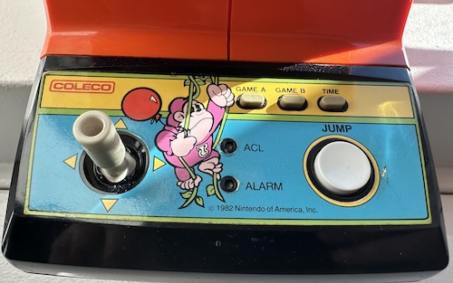 coleco really nailed the art direction Control panel, with a joystick, Game A, B, and time buttons in the top using mushy rubber, a large plastic Jump button, and two small buttons labeled ACL and Alarm that are harder to press