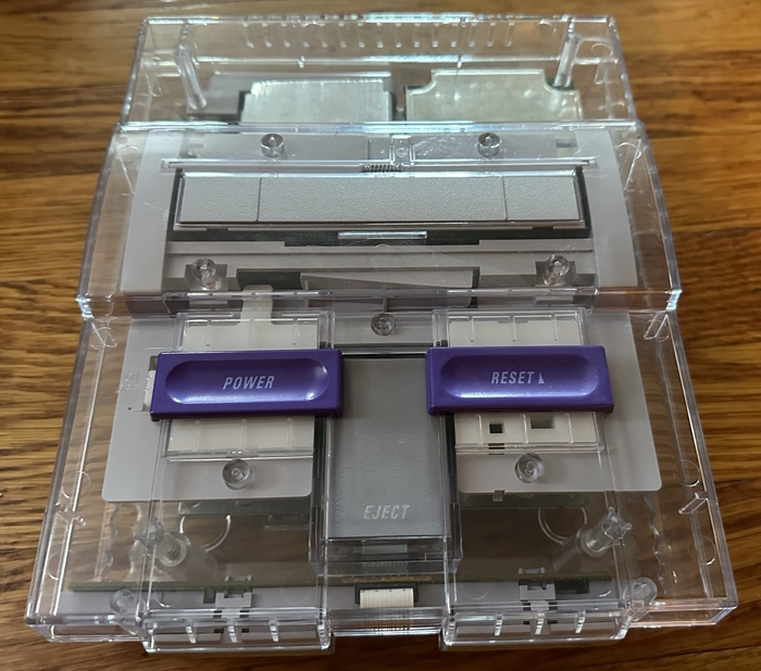 An original Super Nintendo modified with a clear replacement case