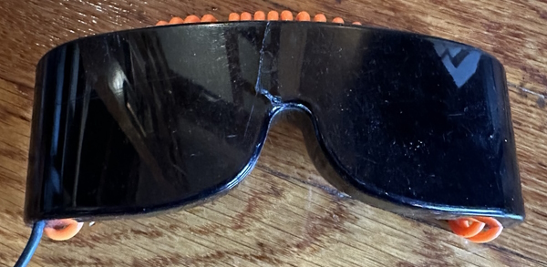 A heavily damaged pair of Sega 3-D glasses