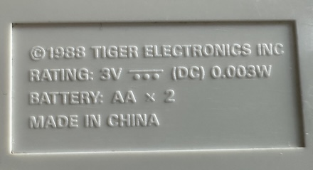Molded plastic with a 1988 copyright date. It also tells us that it uses 2 AA batteries.