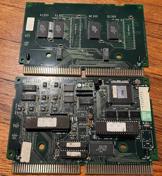 Two boards, with predominately surface-mount chips. The lower one has many more