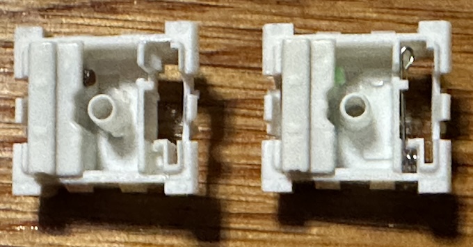 Two open white box switches. One has a metal click line