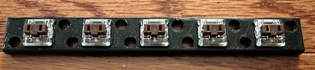 A 3d-printed plate loaded with brown low-profile switches