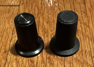 Two potentiometer knobs. One is 3d printed, with a dead giveaway FDM pattern on the top
