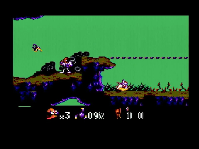Earthworm Jim jumps. At the bottom his lives are displayed in large letters, but the life and ammo are distorted
