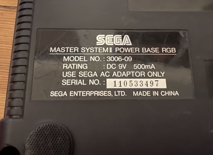a serial number sticker on the back of the Master System II. It refers to the system as the Power Base RGB, model 3006-09.