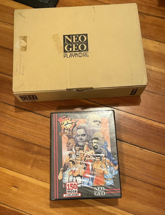 A cardboard box next to an AES cartridge