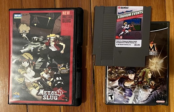 An AES box next to an NES game and a GameCube game