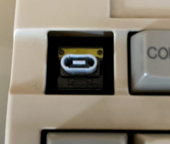 The PC-9800 series keyboard. The 'STOP' keycap is removed, revealing a blue switch