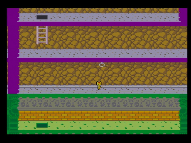Pitfall II arcade attract mode. Minecart tracks are seen with a key sitting on a border between purple and green areas