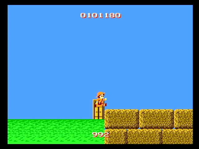Super Pitfall II gameplay. A character jumps onto a rock formation