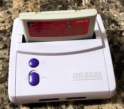 A Super Famicom game fitting into a stock US Super NES