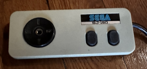 The SG-1000 II's controller. It is a pad now with a round directional pad