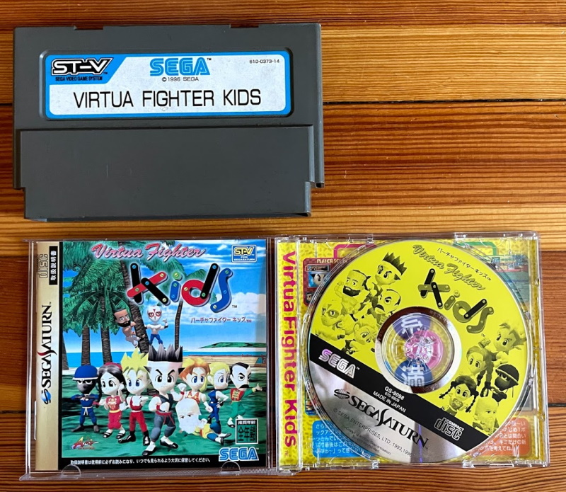 Sega ST-V cartridge compared to a CD-ROM, both 'Virtua Fighter Kids'