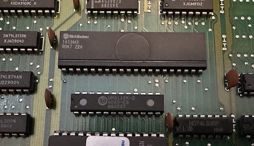 Not sure why it uses a horizontal line at the bottom instead of a notch at the top, maybe that's a sign of who made this? A through-hole chip labeled Nichibutsu 1413M3