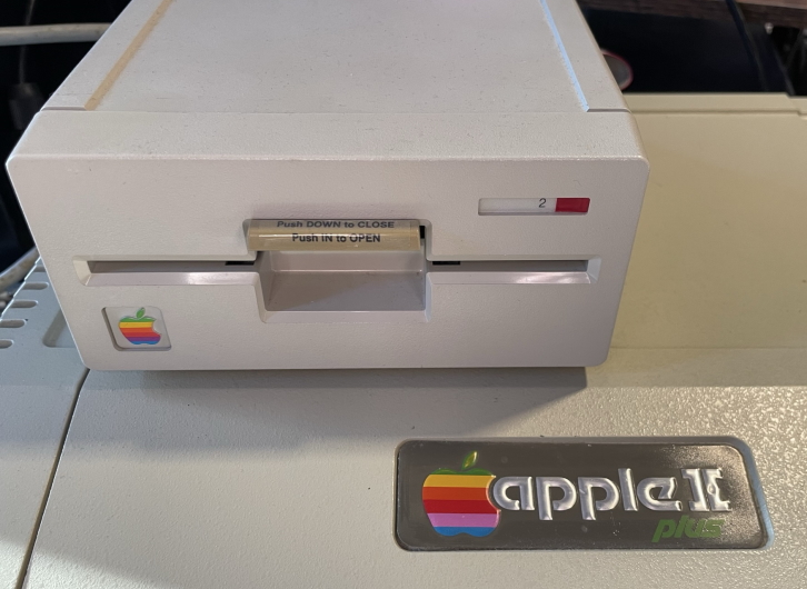 An Apple II disk drive on top of the computer